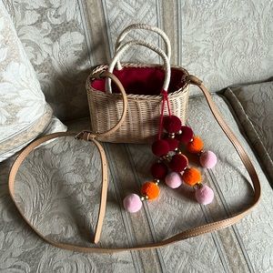 Pompom weaved basket crossbody bag